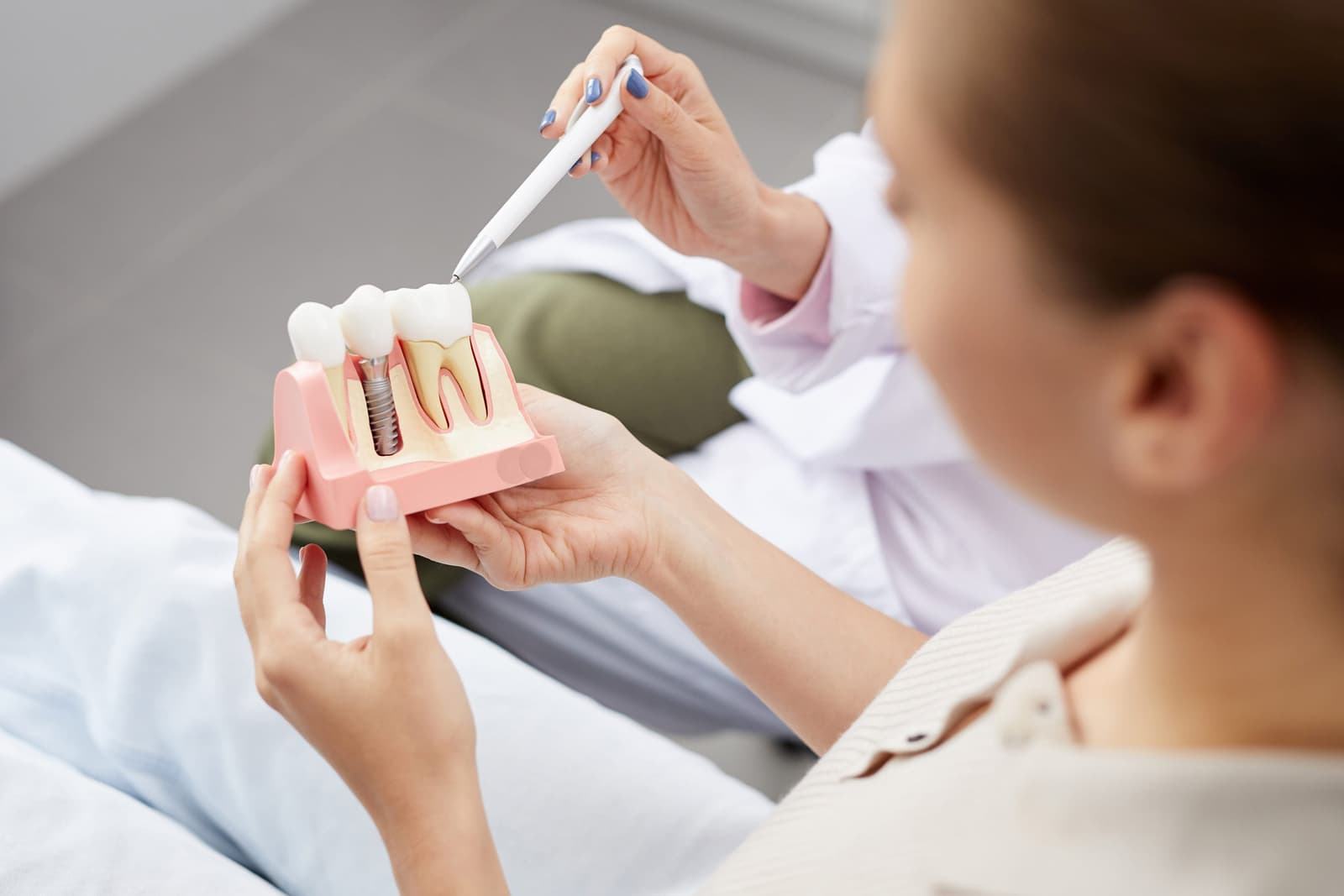 Which lasts longer, dentures or implants?